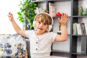 down syndrome girl at home wearing headphones and dancing